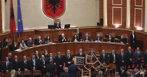 The Albanian opposition disrupts a Parliament vote on the budget with flares and piled-up chairs